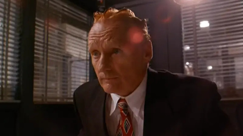 Koopa (Dennis Hopper) sits in an office in Super Mario Bros.