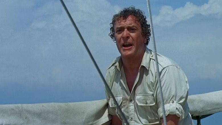 Hoagie (Michael Caine) stands by a mast rigging in Jaws: The Revenge