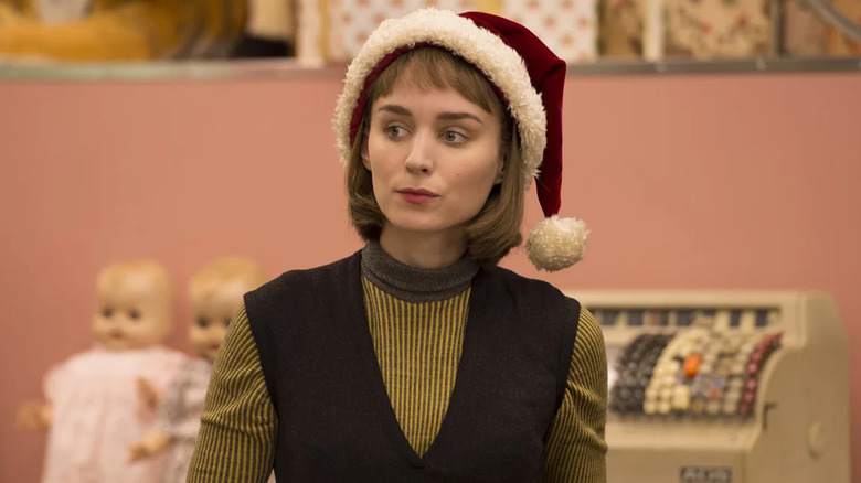 Rooney Mara as Therese Belivet, wearing a Santa hat in Carol.
