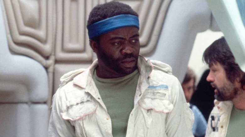 Yaphet Kotto as Parker, scowling in concern with other engineers in Alien.