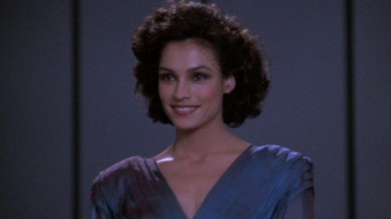 Famke Janssen as Kamala, smiling on Star Trek: The Next Generation.