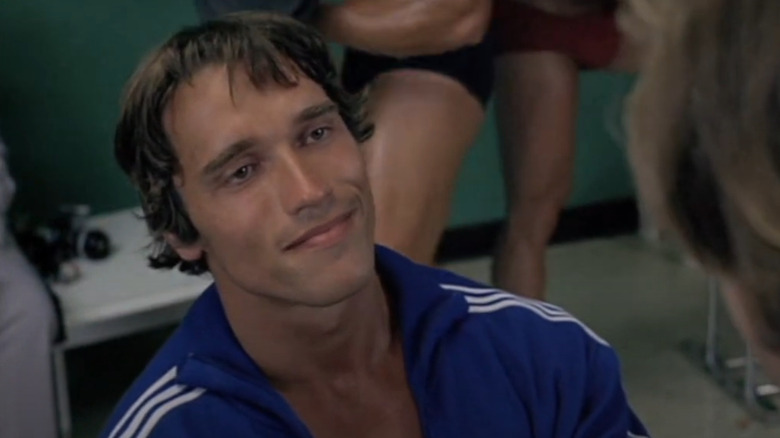Joe (Arnold Schwarzenegger) smiles in a locker room in Stay Hungry