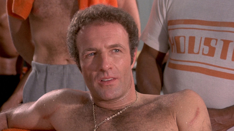 Jonathan E. (James Caan) sits shirtless in Rollerball
