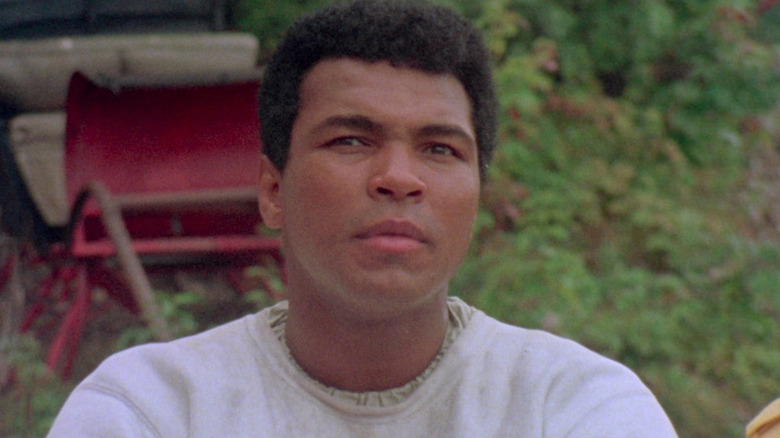 Muhammad Ali outside in a sweatshirt in When We Were Kings