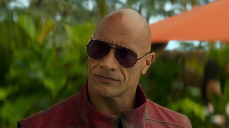 Dwayne Johnson as Cal Drift wearing sunglasses and looking to the side in Red One