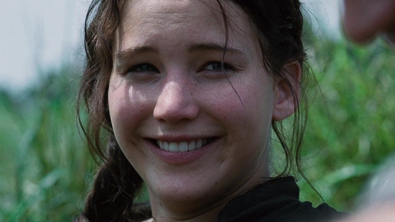 Jennifer Lawrence as Katniss Everdeen smiling in The Hunger Games