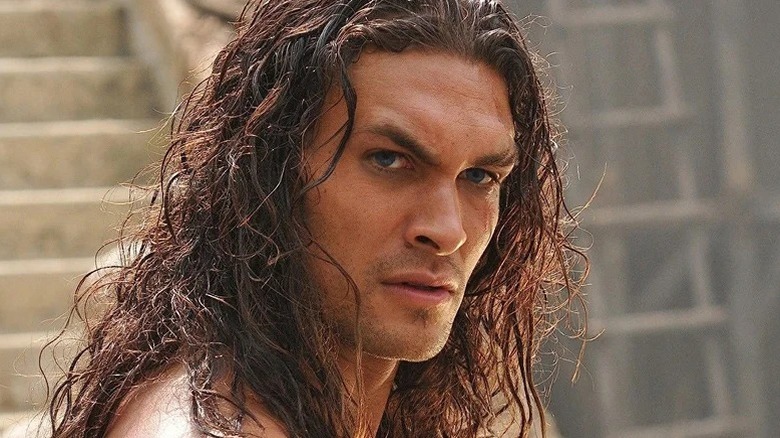 Jason Momoa as Conan looking to the side in Conan the Barbarian