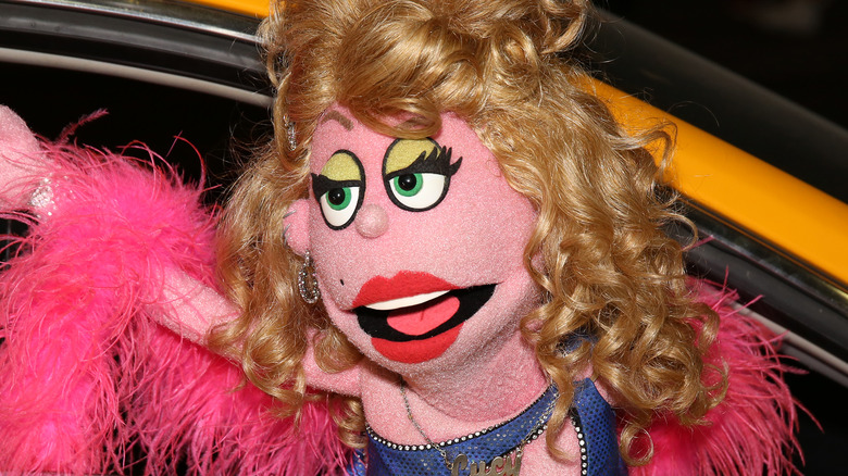 Avenue Q puppet rides a taxi