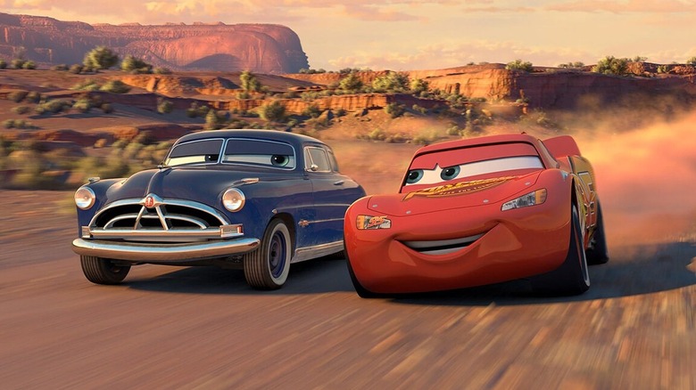 Doc Hudson (Paul Newman) and Lightning McQueen (Owen Wilson) street racing in Cars (2006)