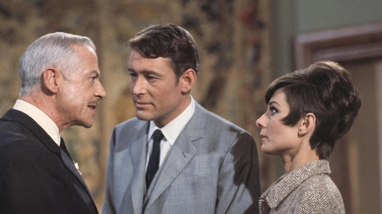DeSolnay (Charles Boyer) speaks sternly to Simon Dermott (Peter O'Toole) and Nicole Bonnet (Audrey Hepburn) in How to Steal a Million