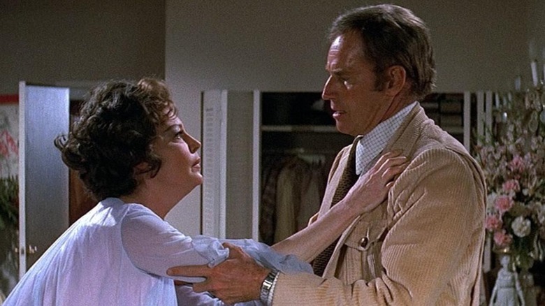 Remy Royce-Graff (Ava Gardner) moves to embrace Stewart Graff (Charlton Heston) in Earthquake (1974)