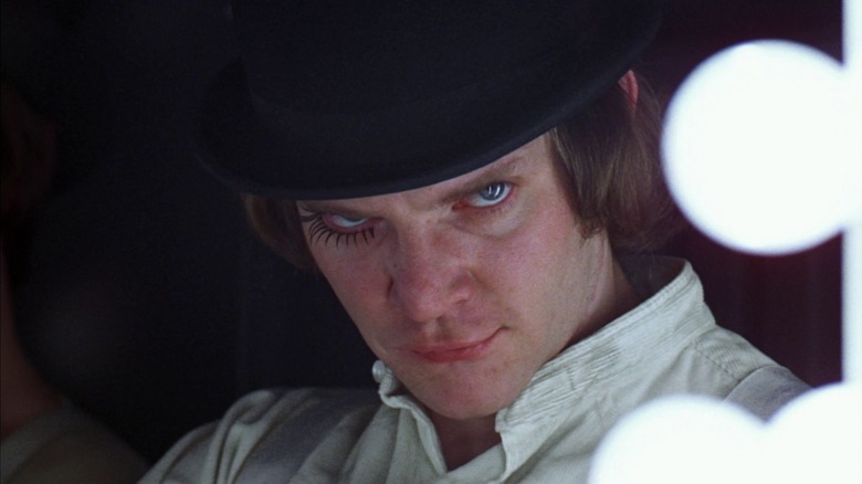 Malcolm McDowell as Alex DeLarge in A Clockwork Orange, looking sinister at the camera.