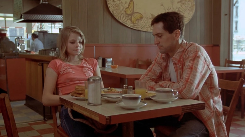 Robert DeNiro as Travis Bickle sitting at breakfast in a diner with Jodie Foster as Iris in Taxi Driver
