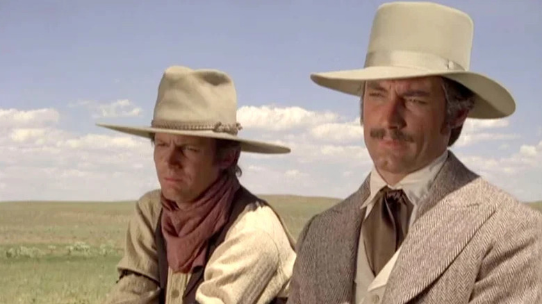 Oliver Seccombe (Timothy Dalton) stares alongside a rancher in Centennial