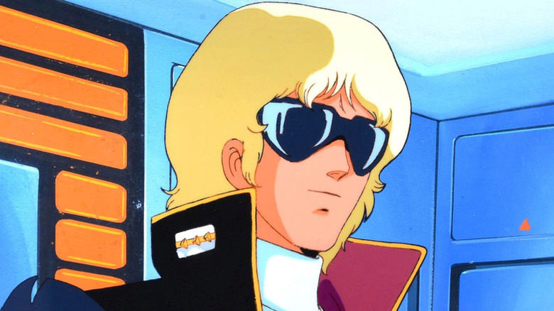 Quattro Bajeena stands wearing sunglasses in Mobile Suit Zeta Gundam