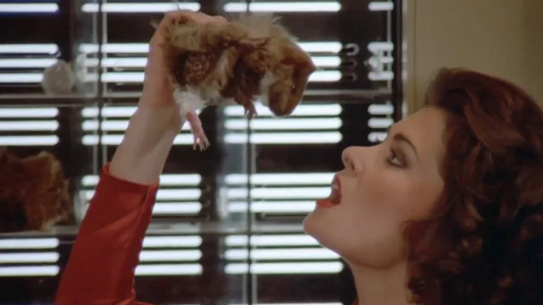Diana (Jane Badler) prepares to eat a guinea pig in V (1983)