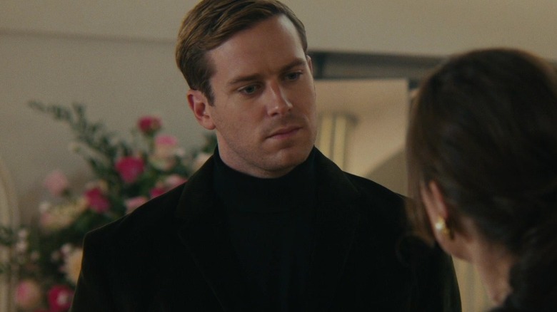 Armie Hammer as Illya Kuryakin looking at a lady in The Man from U.N.C.L.E.