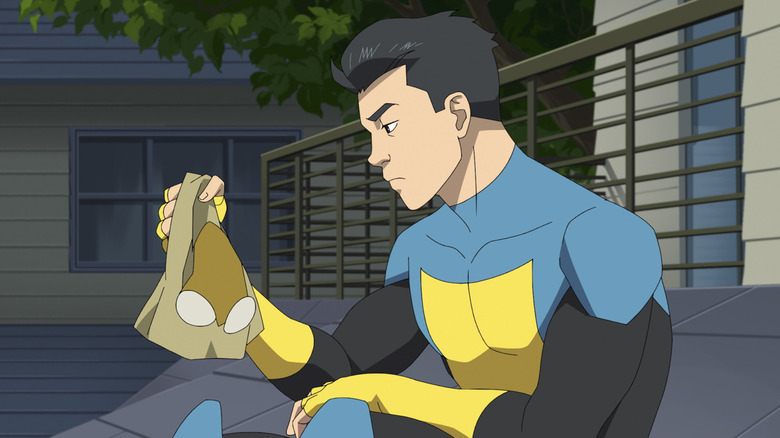 Mark Grayson looks at his mask in Invincible