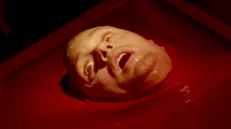 Alexander Skarsgård as a clone of James, waking up in red liquid in Infinity Pool
