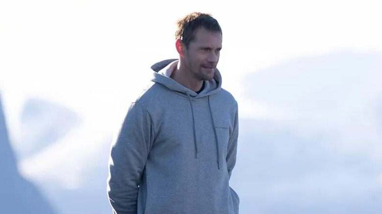 Alexander Skarsgård as Lukas Matsson, standing on a mountain on Succession