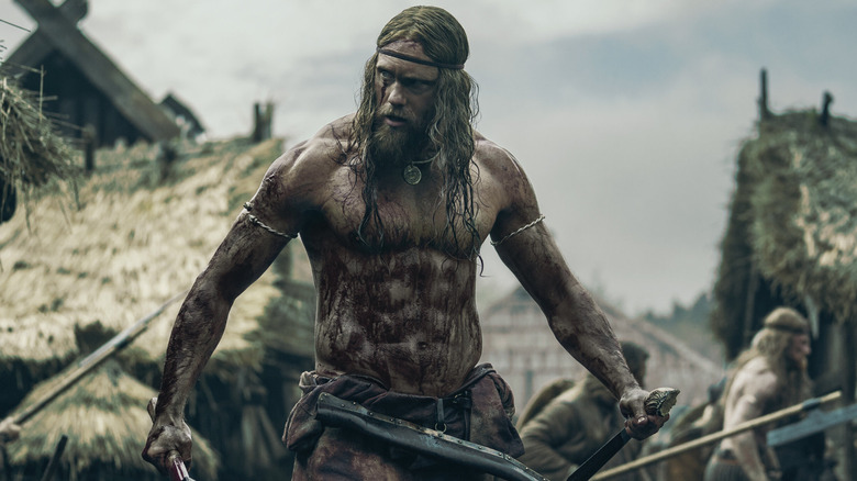 Alexander Skarsgård as Amleth, standing bloody in a village in the northman
