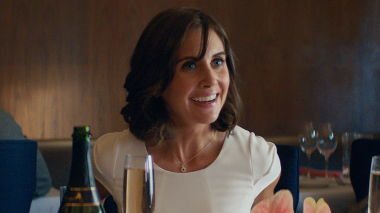 Alison Brie as Madison, smiling in a restaurant in Promising Young Woman