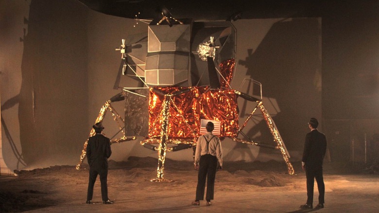 three CIA agents standing before a fake lunar lander module in Operation Avalanche