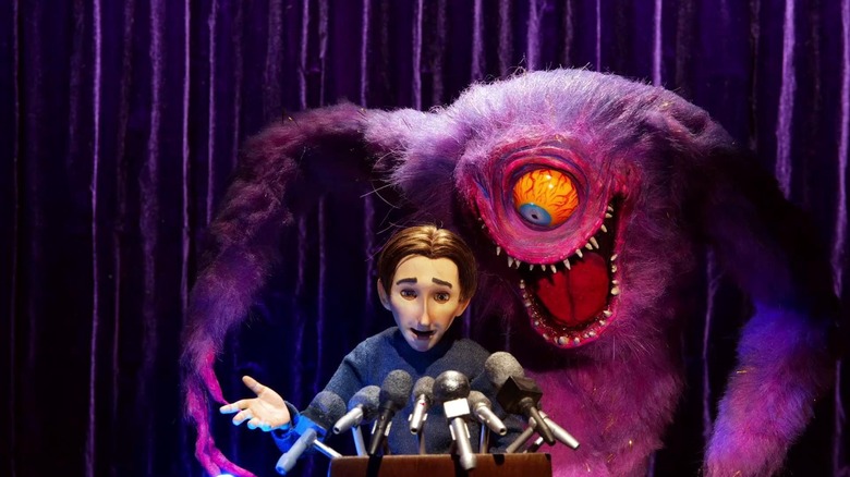 One-eyed monster looking over a man's shoulder on The Shivering Truth