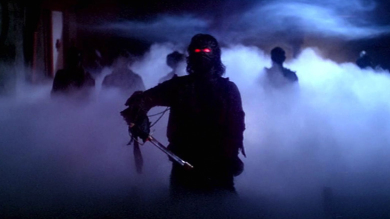 A group of ghost pirates stand in a foggy church in The Fog (1980)