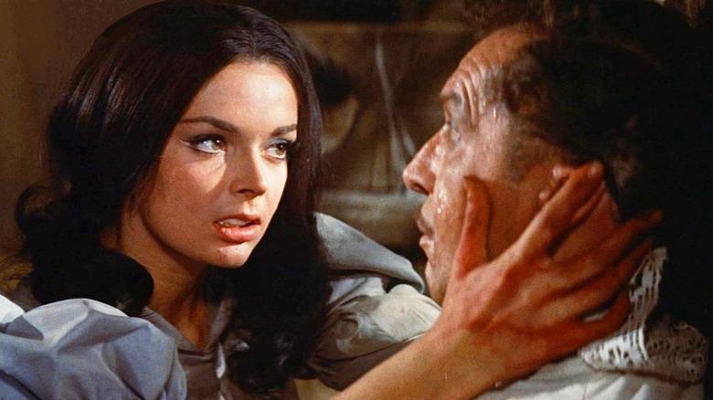 Elizabeth (Barbara Steele) holds a shocked Nicholas Medina (Vincent Price) in The Pit and the Pendulum (1961)