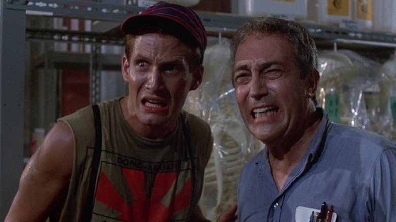 Freddy Hanscom (Thom Mathews) and Frank Johnson (James Karen) react in disgust in a medical storeroom in The Return of the Living Dead