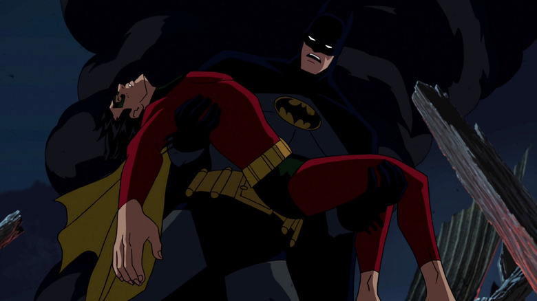 Bruce Greenwood as Bruce Wayne / Batman in Batman: Under the Red Hood, holding a limp Jason Todd/Robin (Jensen Ackles).