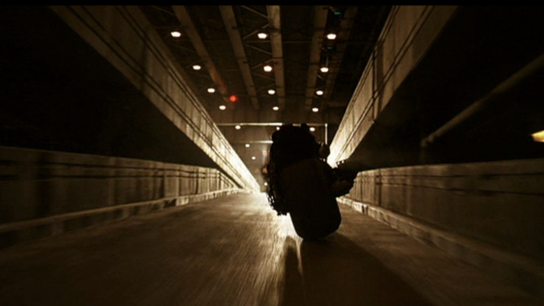 Batman (Christian Bale) rides away in The Dark Knight