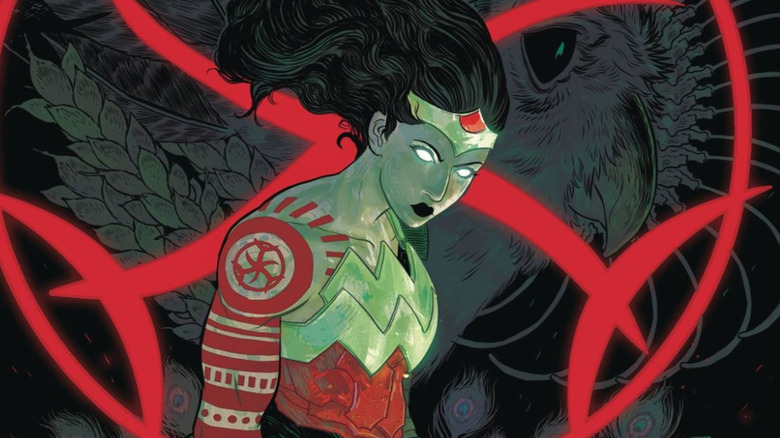Absolute Wonder Woman stands with glowing eyes before a red symbol