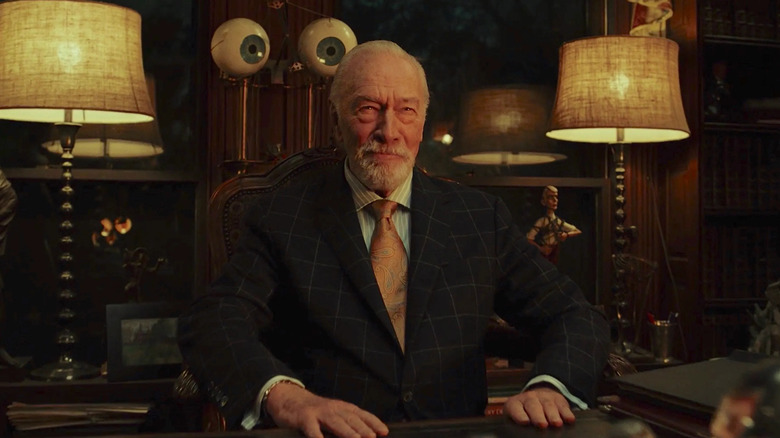 Christopher Plummer as Harlan Thrombey, sitting in his study in Knives Out