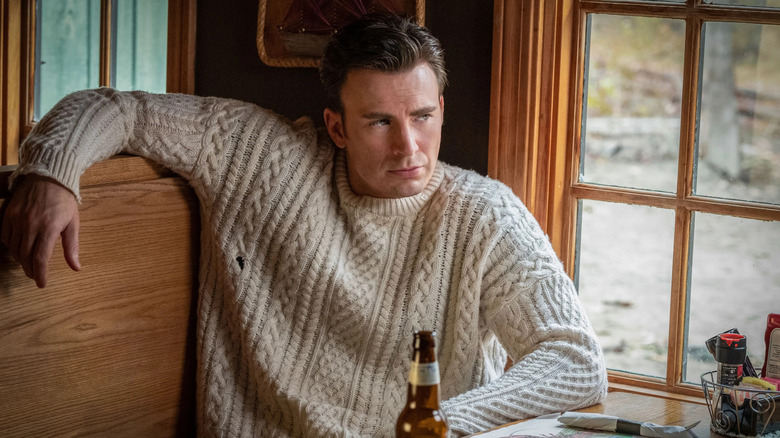 Chris Evans as Hugh Ransom Drysdale, sitting in a bar booth in Knives Out