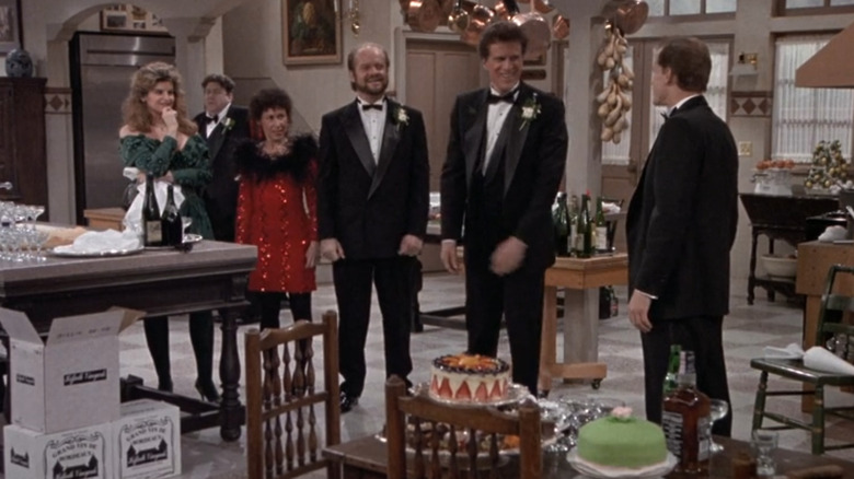Kirstie Alley as Rebecca Howe, George Wendt as Norm Peterson, Rhea Perlman as Carla Tortelli, Kelsey Grammer as Frasier Crane, Ted Danson as Sam Malone, and Woody Harrelson as Woody Boyd at Woody's wedding in Cheers