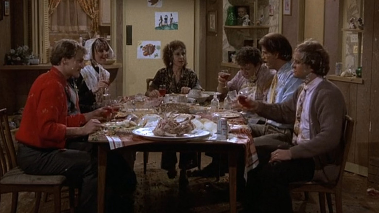 Woody Harrelson as Woody Boyd, John Ratzenberger as Cliff Clavin, Shelley Long as Diane Chambers, Rhea Perlman as Carla Tortelli, George Wendt as Norm Peterson, Ted Danson as Sam Malone and Kelsey Grammer as Frasier Crane covered in food during Thanksgiving in Cheers