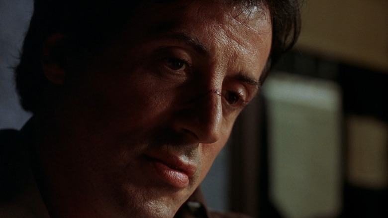 A sweaty Freddy Heflin (Sylvester Stallone) looks down in the shadows in Cop Land