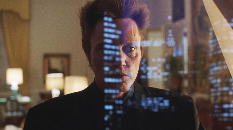 Frank White (Christopher Walken) stares out a window at a nighttime cityscape in King of New York