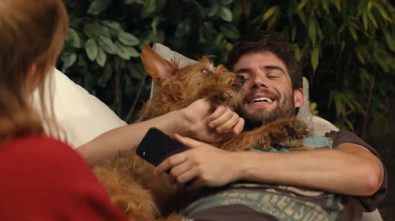 Max (David Corenswet) cuddling dog in The Greatest Hits