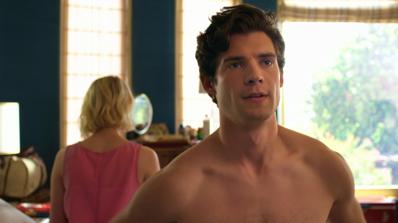 River (David Corenswet) sitting on bed shirtless in The Politician