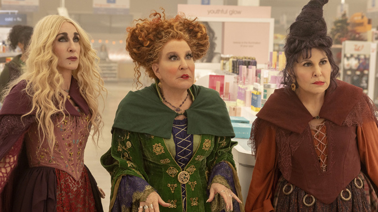 Sarah Jessica Parker as Sarah Sanderson, Bette Midler as Winifred Sanderson, and Kathy Najimy as Mary Sanderson looking confused in Walgreens in Hocus Pocus 2