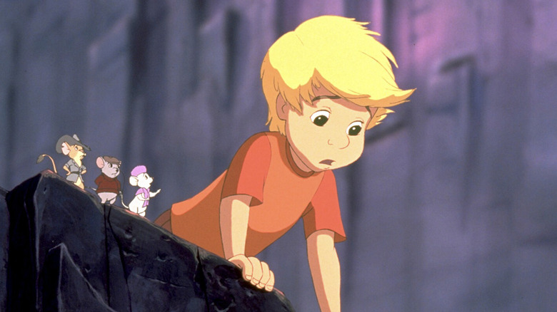Jake (voiced by Tristan Rogers), Bernard (voiced by Bob Newhart), and Bianca (voiced by Eva Gabor) talking to Cody (voiced by Adam Ryen) looking over a cliff in The Rescuers Down Under