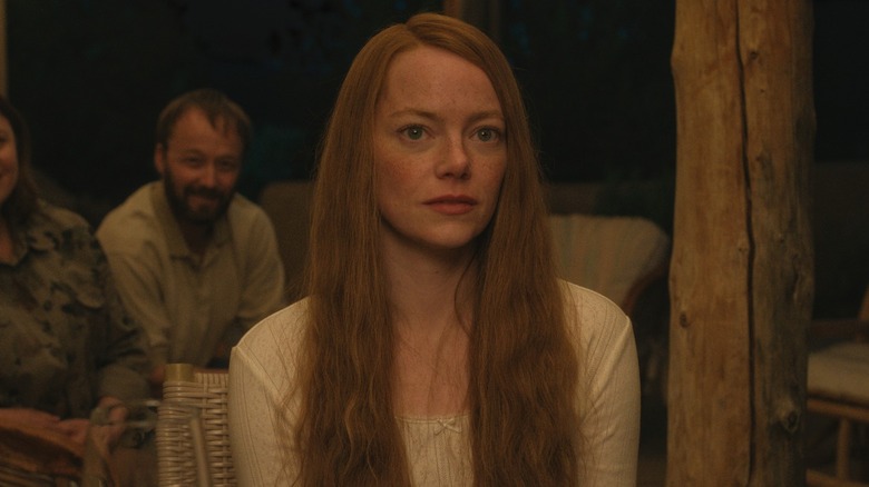 Emma Stone sitting and staring as Louise Cross in Eddington
