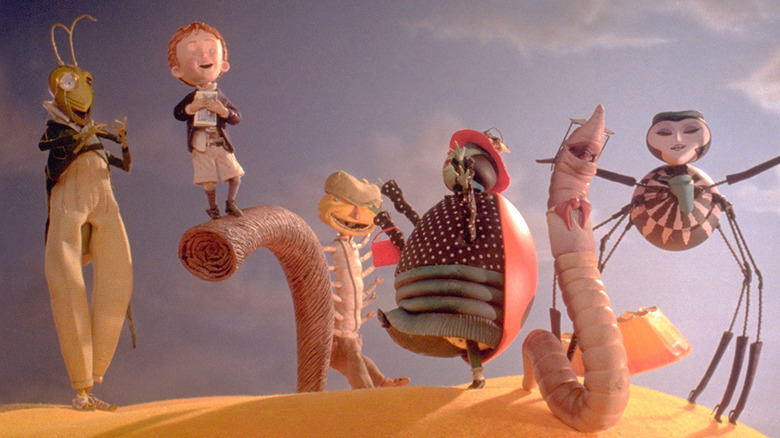 Mr. Grasshopper, James Henry Trotter, Mr. Centipede, Mrs. Ladybug, Mr. Earthworm, and Miss Spider celebrate aboard the peach in James and the Giant Peach