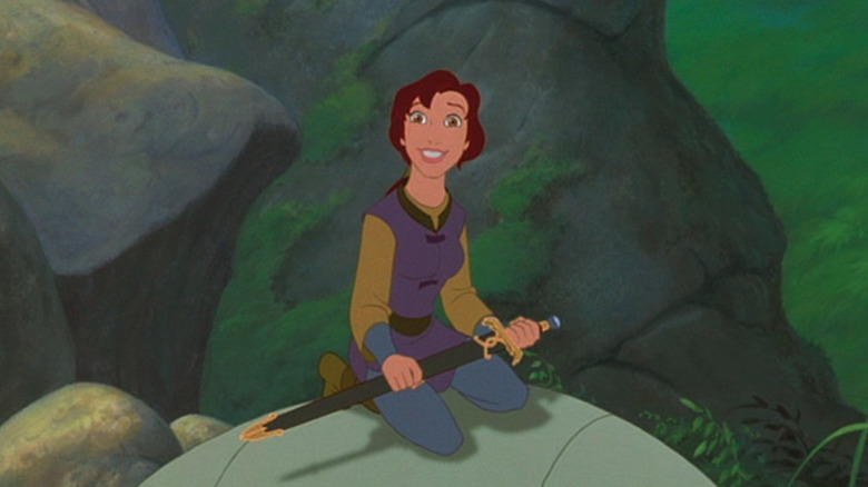 Kayley smiles while holding a sword in the forest in Quest For Camelot