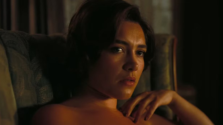 Florence Pugh sitting in a chair as Jean Tatlock in Oppenheimer