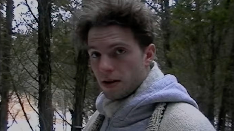 James Seward as James "Jim" L. Suerd in The Last Broadcast, looking at the person holding the camera filming him as he stands out in the woods.