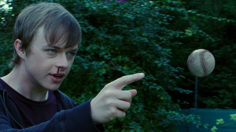 Dane DeHaan as Andrew Detmer with a bloody nose pointing at a hovering baseball he's controlling with his mind in Chronicle